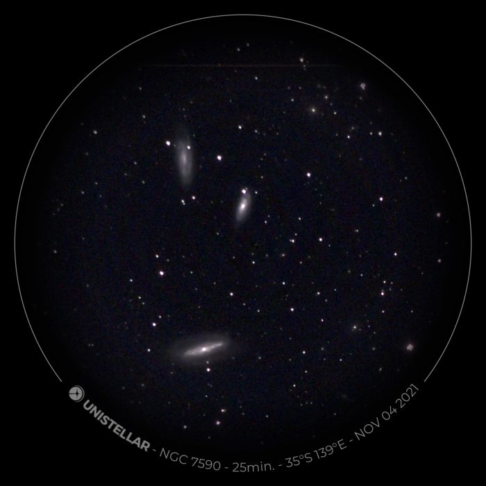 Name: Ian Blackwell Instagram: n/a Camera: Sony IMX224  Telescope: Unistellar eVscope Subject: NGC7590 - one of the Grus Quartet Photo Taken: n/a Image Duration: 25 minute exposure  Software used: None Filters used: None Photo Information: NGC7590 - one of the Grus Quartet. The FOV on the eVscope won't accommodate all four, but here are three of the galaxies.